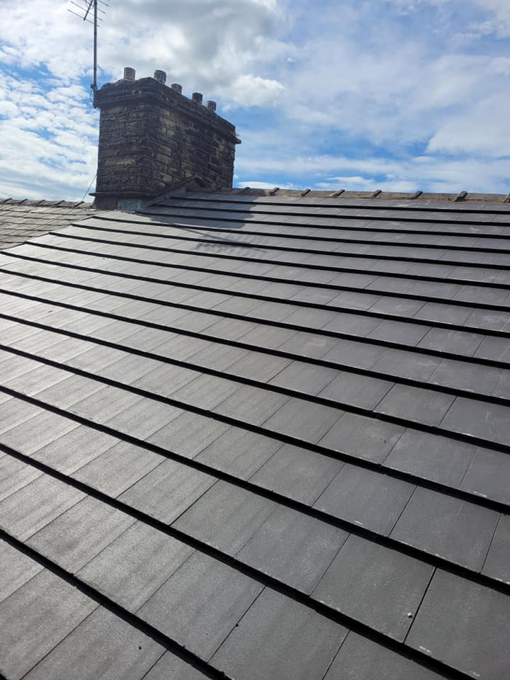 Roofer working on a slate roof in Accrington Lancashire